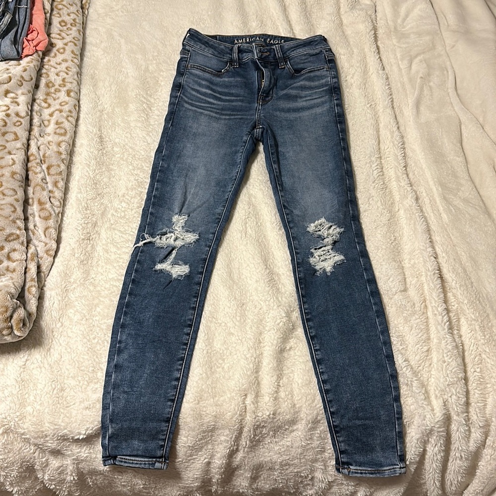 American Eagle next level stretch jeans, size 2, blue washed with rips on knees